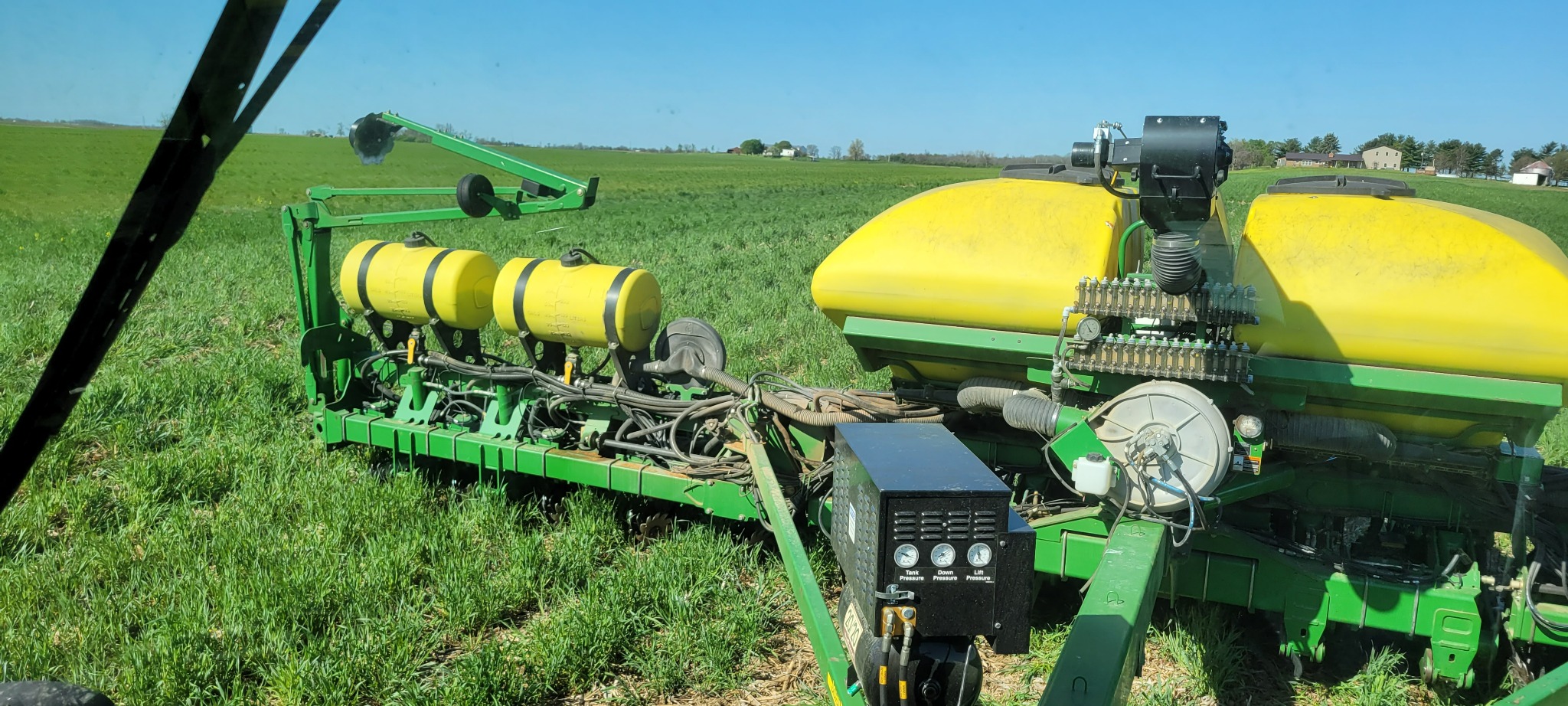 Side view of a planter equipped with liquid starter fertilizer tanks and delivery system